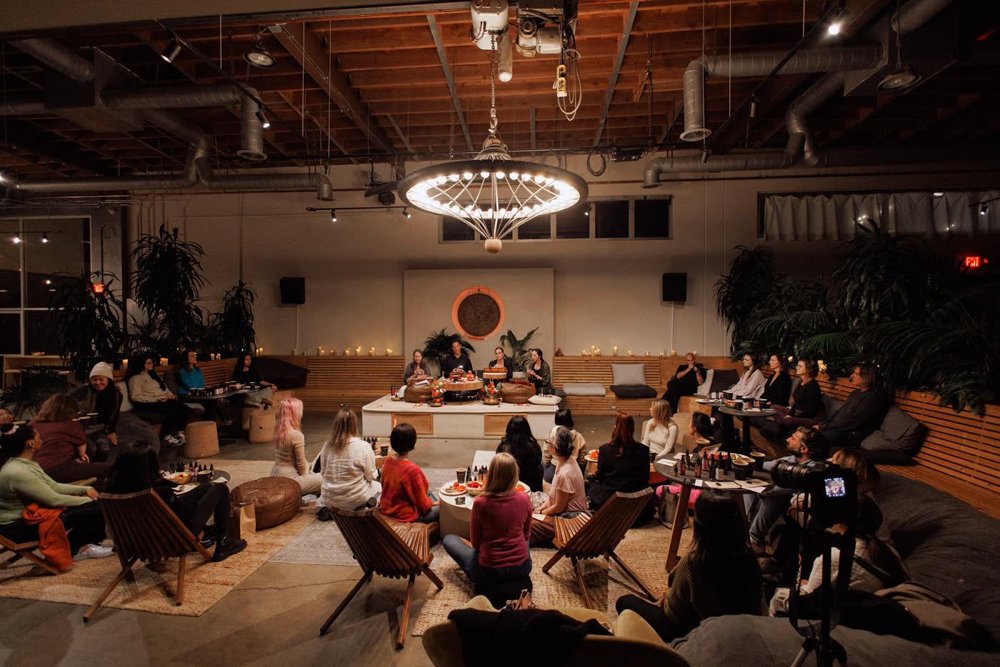 Guests gathered in a circle in a warm loft space