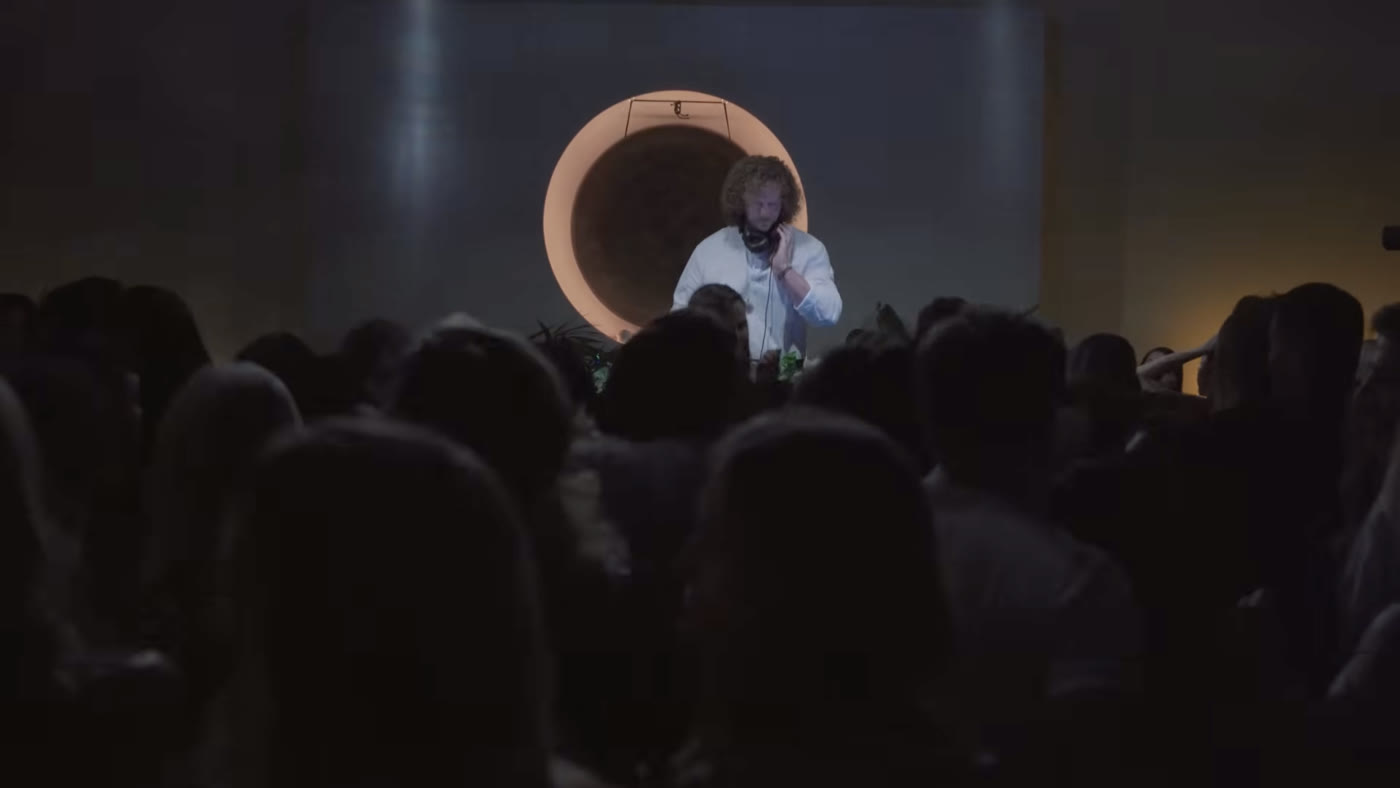 A performance on stage, seen over the crowd