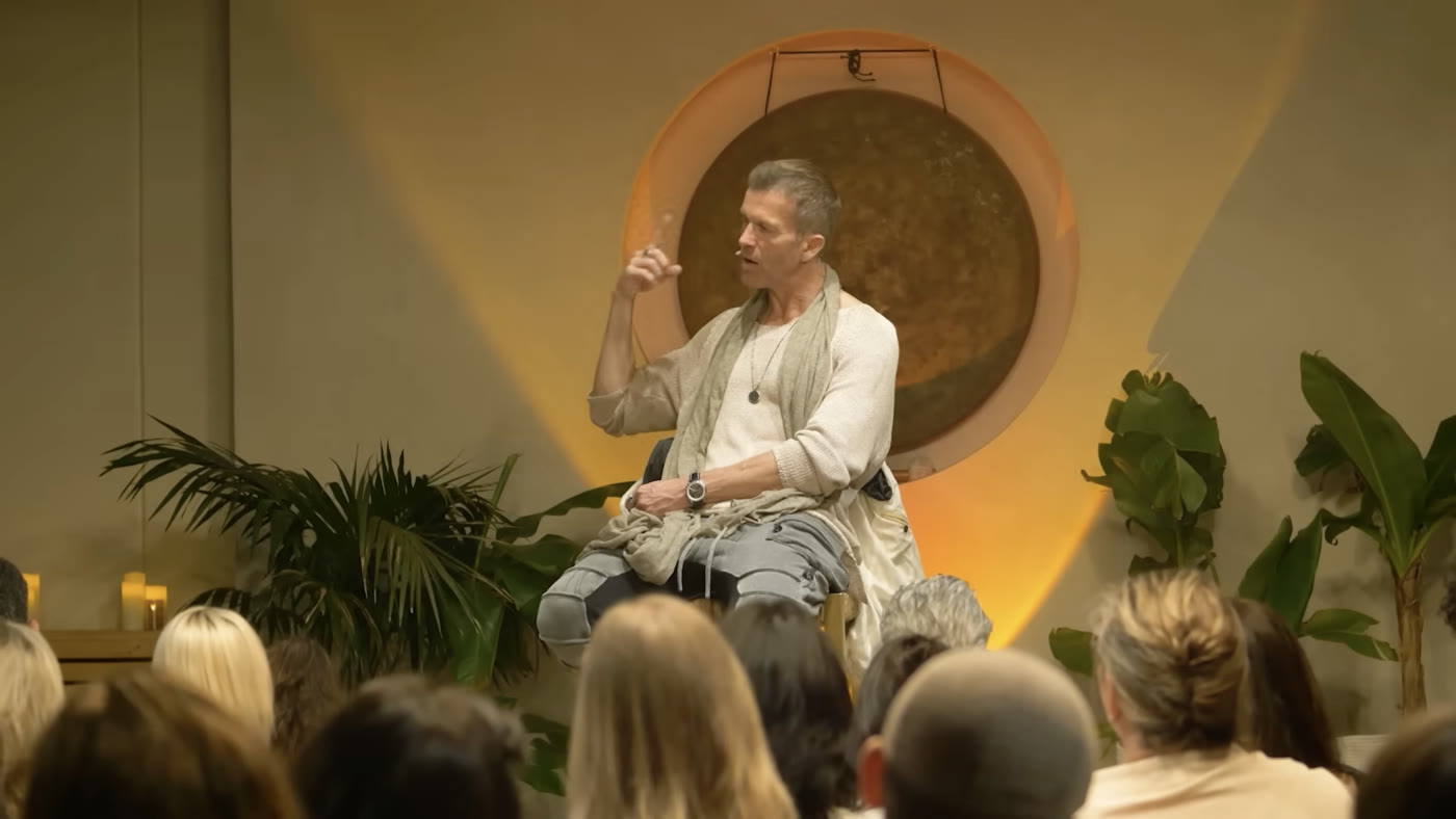 Speaker in conversation before a seated audience